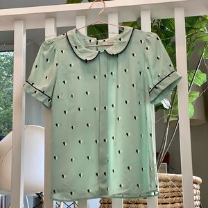 Mint-green blouse with heart print detail collar. Sophisticated Parisian chic.